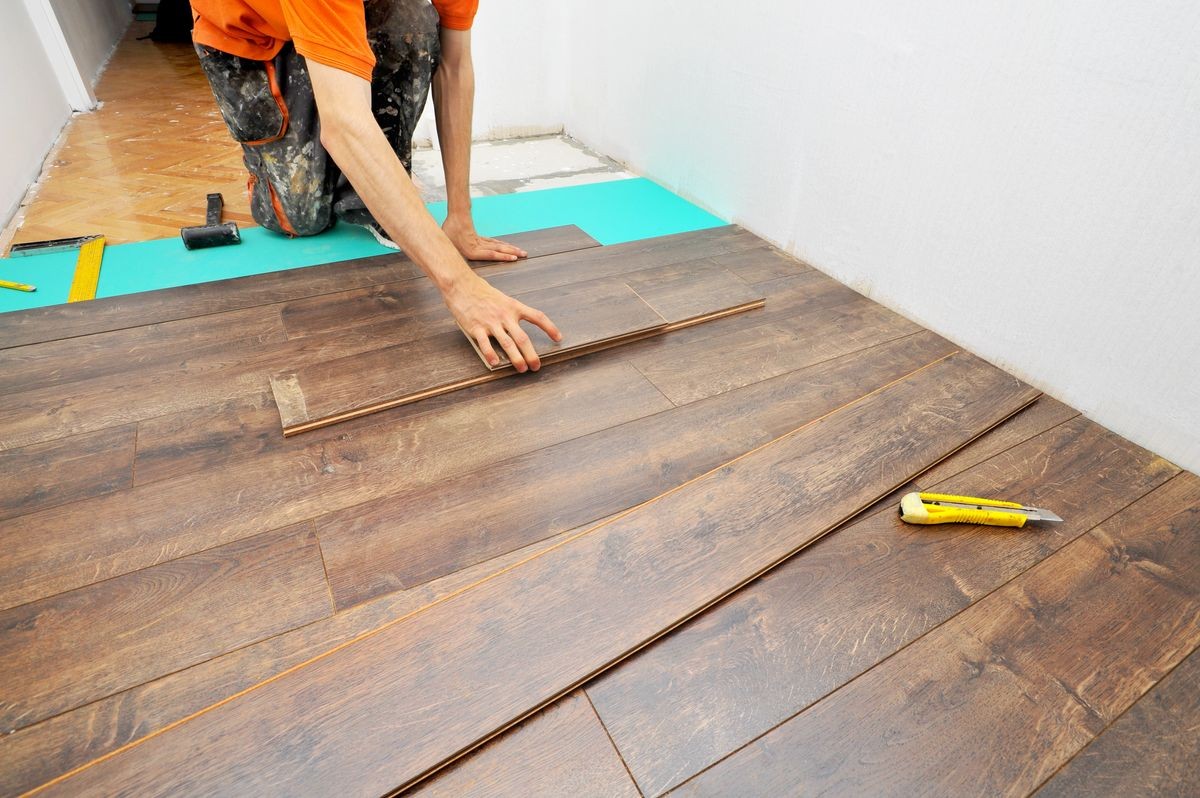 Worker carpenter doing laminate floor work